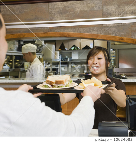 Customer receiving tray of food in bakery Customer receiving tray of food in bakery 10624082