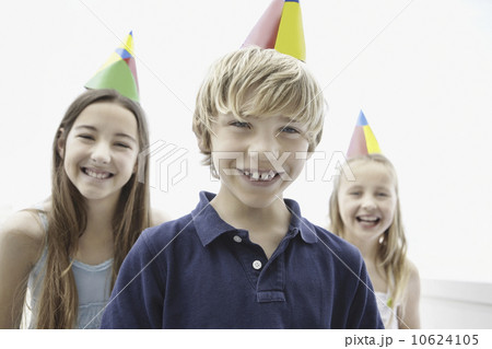 Three children wearing birthday hats Three children wearing birthday hats 10624105