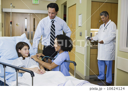Girl in hospital gurney with father and nurse 10624124