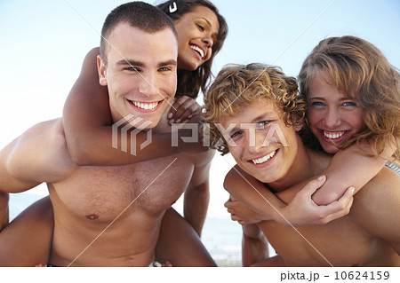 Young men carrying girlfriends on backs Young men carrying girlfriends on backs 10624159