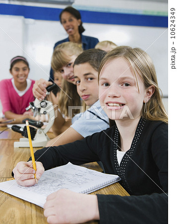 Teacher and elementary students looking at microscope Teacher and elementary students looking at microscope 10624349