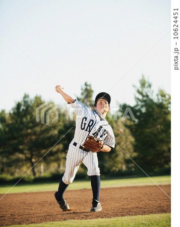Boy (10-11) playing baseball 10624451