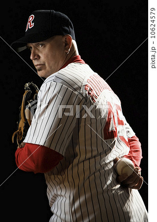 Pitcher holding baseball behind back 10624579