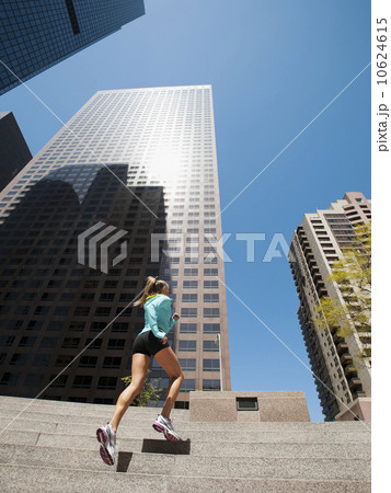 USA, California, Los Angeles, Young woman running on stairs 10624615