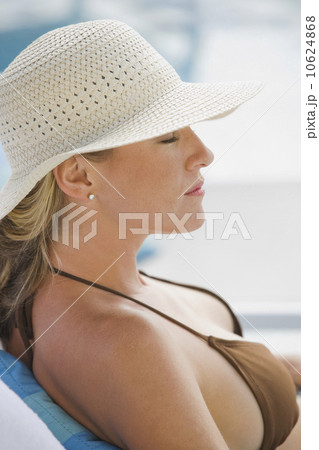 Woman relaxing poolside 10624868