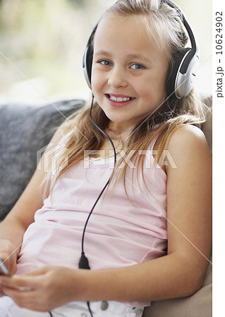 Girl (10-11) listening to mp3 player Girl (10-11) listening to mp3 player 10624902