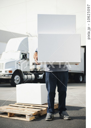 Warehouse worker carrying stack of boxes Warehouse worker carrying stack of boxes 10625097