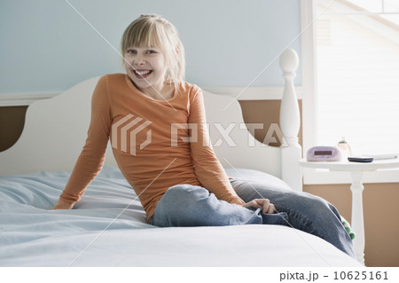 Girl sitting on bed 10625161