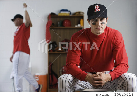 Baseball player looking pensive in locker room Baseball player looking pensive in locker room 10625612