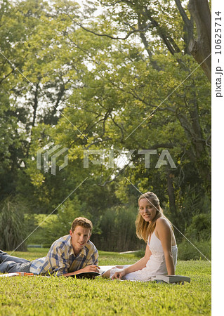 Portrait of college students studying in grass 10625714