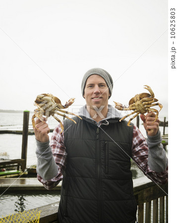 Portrait of man showing crabs Portrait of man showing crabs 10625803