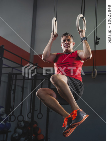 Mature man doing pull-ups with acrobatic rings Mature man doing pull-ups with acrobatic rings 10625849