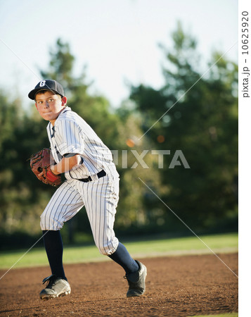 Boy (10-11) playing baseball 10625920