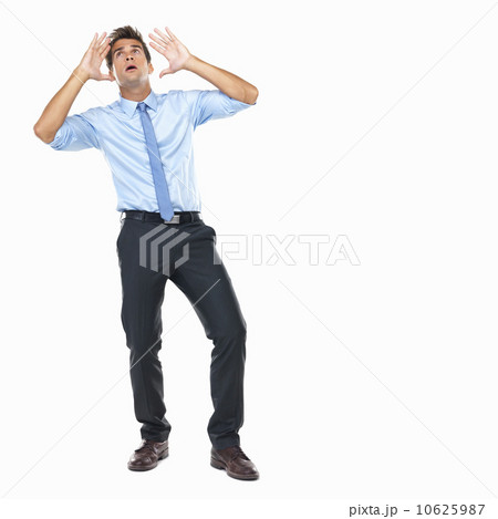 Studio shot of overwhelmed business man looking up Studio shot of overwhelmed business man looking up 10625987