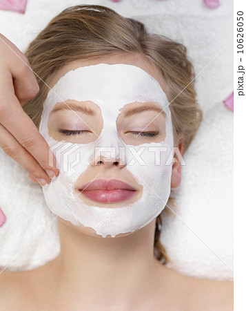 Young woman getting facial spa treatment Young woman getting facial spa treatment 10626050