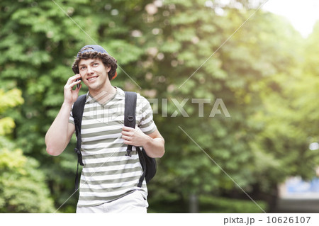 Male college student talking on cell phone Male college student talking on cell phone 10626107