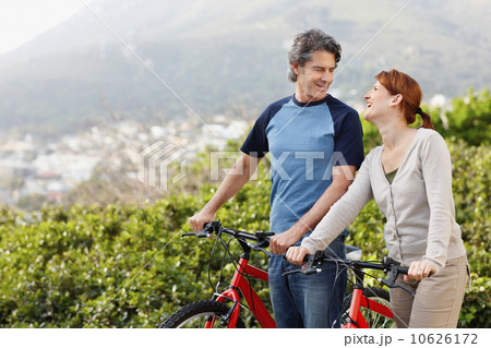 Cyclists standing beside their bikes 10626172