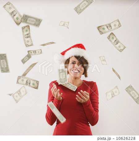 Money raining down on woman in Santa Claus hat Money raining down on woman in Santa Claus hat 10626228