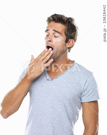 Studio portrait of young man yawning 10626442