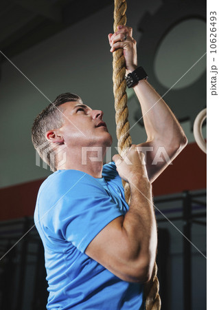 Mature man climbing up rope Mature man climbing up rope 10626493