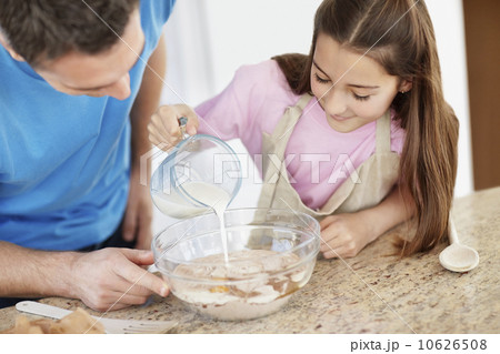 Daughter (10-11) helping father prepare food Daughter (10-11) helping father prepare food 10626508