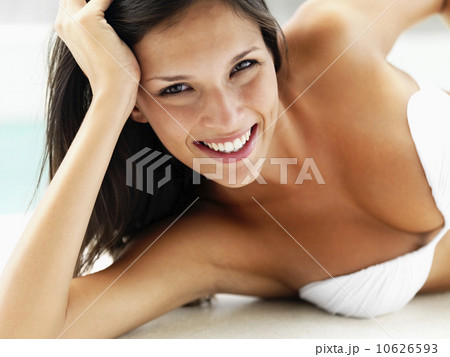 Woman relaxing by pool Woman relaxing by pool 10626593