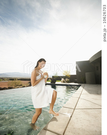 Young attractive woman emerging from swimming pool 10626703