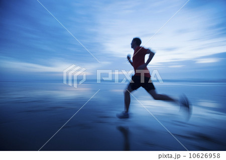 Man running along beach 10626958