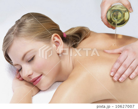 Young woman getting oil massage Young woman getting oil massage 10627007