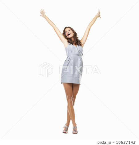 Studio shot of young excited woman celebrating success with hands raised Studio shot of young excited woman celebrating success with hands raised 10627142