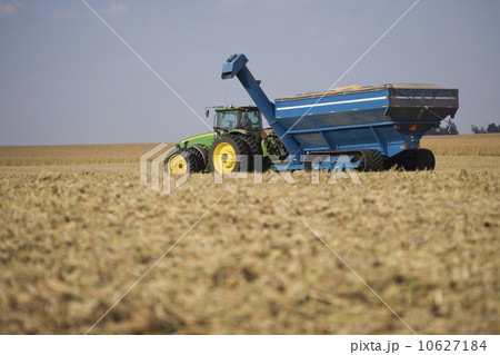 Tractor hauling grain in field 10627184