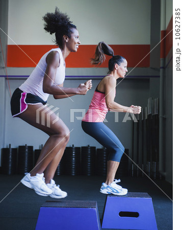 Two women in step aerobics class Two women in step aerobics class 10627385