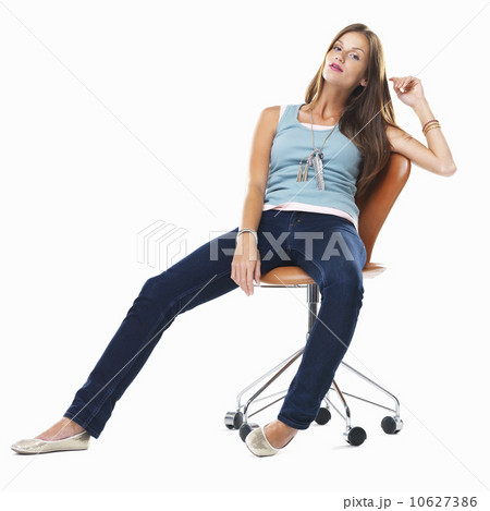 Confident woman sitting comfortably on chair against white background Confident woman sitting comfortably on chair against white background 10627386