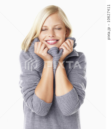 Studio portrait of young woman wearing gray sweater Studio portrait of young woman wearing gray sweater 10627411