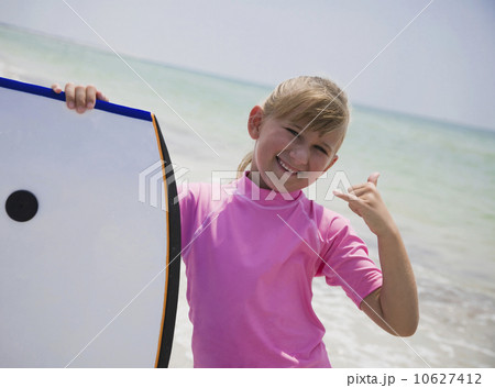 Young girl holding boogie board, Florida, United States 10627412