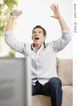 Man cheering in front of television 10627449