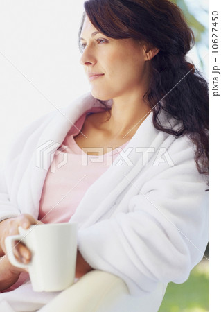 Woman in bathrobe drinking coffee 10627450