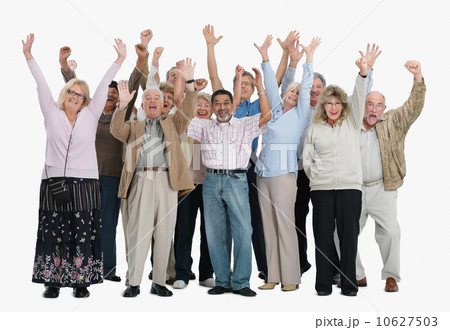 A group of excited people raising their arms in the air 10627503