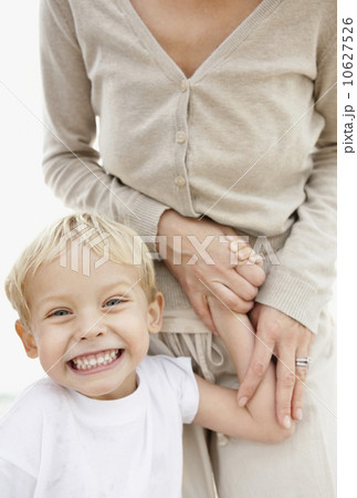 Portrait of boy (4-5) holding mother hand and making face Portrait of boy (4-5) holding mother hand and making face 10627526