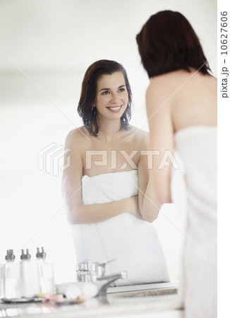 Woman looking at her reflection in mirror 10627606