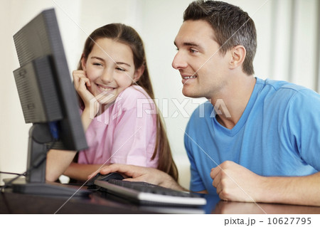 Father with daughter (10-11) playing with computer Father with daughter (10-11) playing with computer 10627795