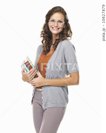 Studio portrait of cute smiling woman holding notebooks 10627879