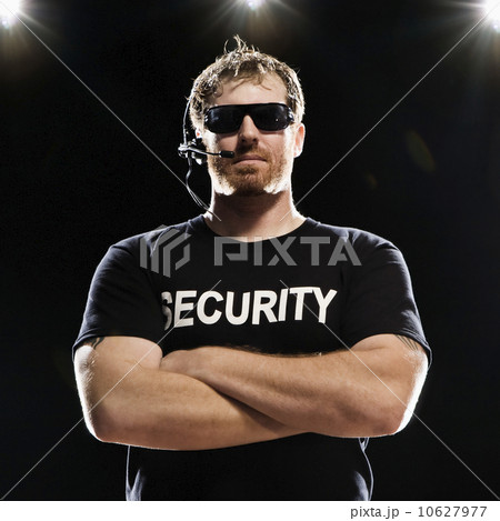 Security guard with headset posing with arms crossed Security guard with headset posing with arms crossed 10627977
