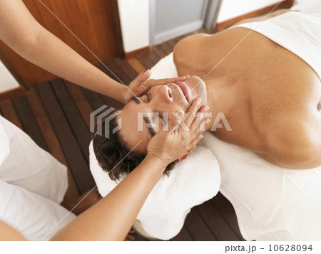 Man getting facial massage in spa Man getting facial massage in spa 10628094