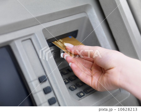 Woman using cash machine 10628213