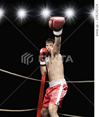 Boxer extending arm in boxing ring 10628224