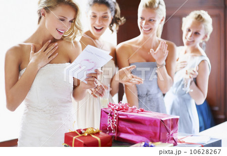 Bride  and bridesmaids unpacking gifts 10628267