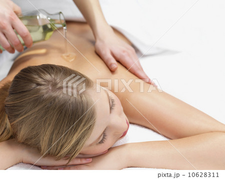 Young woman getting oil massage Young woman getting oil massage 10628311