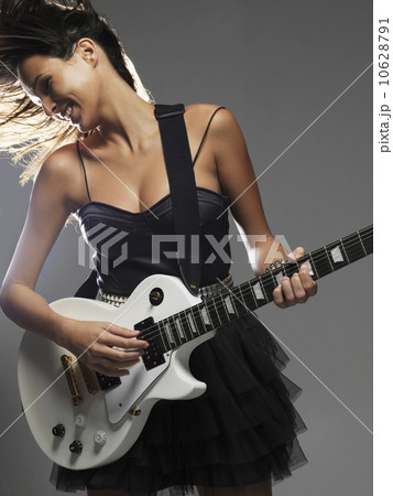 Studio shot of woman playing electric guitar 10628791