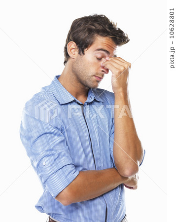 Stressed male executive standing and rubbing nose Stressed male executive standing and rubbing nose 10628801